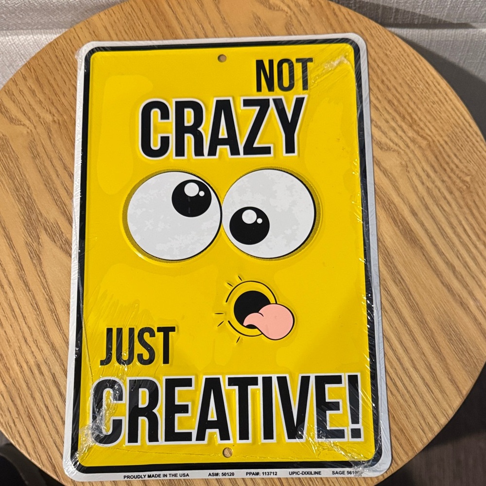 Yellow 'Not Crazy Just Creative' Sign